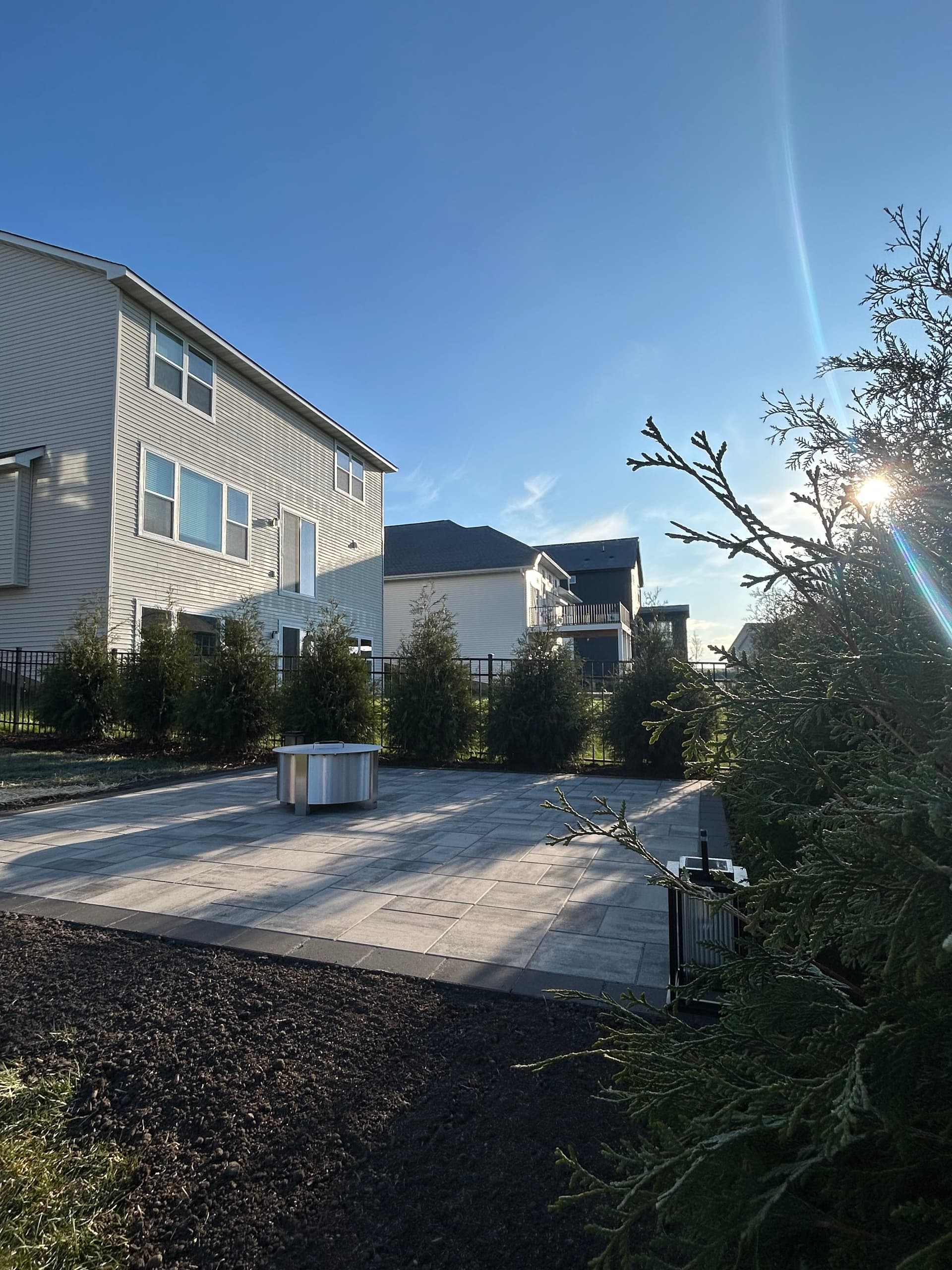 Gallery photos for Paver Patio and Privacy Trees Built for Real Backyard Living: Image #1